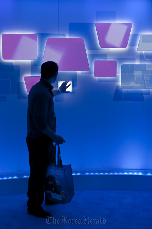 An attendee interacts with a touch sensitive Microsoft Corp. display during the 2010 International Consumer Electronics Show in Las Vegas. Bloomberg