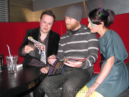 The creators of Neh Magazine examine a recent edition.
Neh magazine’s publisher CJ Koster-Alle, art director Chris White and style director Jessica McCormick look through a copy of the magazine. Rob York/The Korea Herald