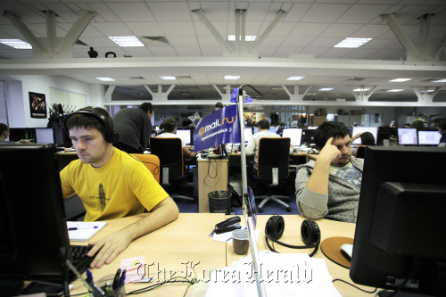 Employees work on computers at the Mail.ru Group Ltd. headquarters in Moscow, Russia. Bloomberg