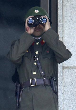 A North Korean Army soldier looks at the southern side using binoculars at the border village of Panmunjom, (DMZ), that separates the two Koreas since the Korean War. (AP)