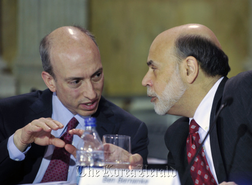 Gary Gensler, chairman of the U.S. Commodity Futures Trading Commission (left) confers with Ben S. Bernanke, chairman of the Federal Reserve, during a meeting of the Financial Stability Oversight Council at the Treasury Department in Washington, D.C., on Tuesday.  Bloomberg
