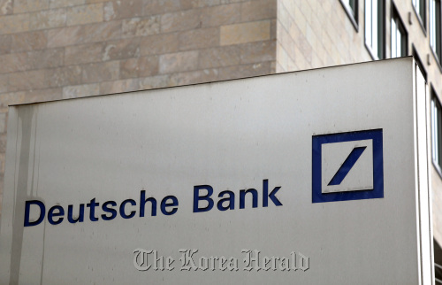A Deutsche Bank AG logo is seen on one of the bank’s branches in Frankfurt, Germany.  Bloomberg