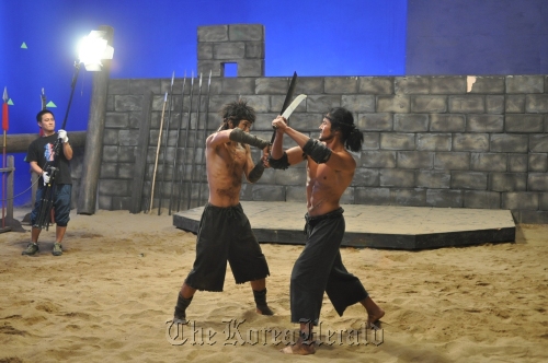 Lead actor Cho Dong-hyeok (right) films a gladiator action sequence for OCN’s “Yaksa.”   OCN