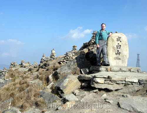 David Mason stands on top of 1572.9-meter Mount Hambaek, part of the Baekdu-daegan mountain system.