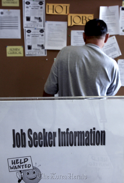 A job seeker looks at postings for jobs at the Verdugo Jobs Center in Glendale, California, United States. Bloomberg