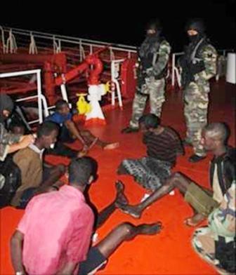 In this photo taken on Thursday, Jan. 20, 2011 and released by Royal Malaysian navy, its commandos keep watch on detained Somali pirates on Malaysian tanker MT Bunga Laurel in the Gulf of Aden. (AP-Yonhap News)