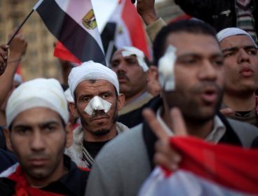 Wounded anti-government protestors march during a demonstration in Tahrir Square, Cairo, Egypt, on Friday. (Yonhap-AP)