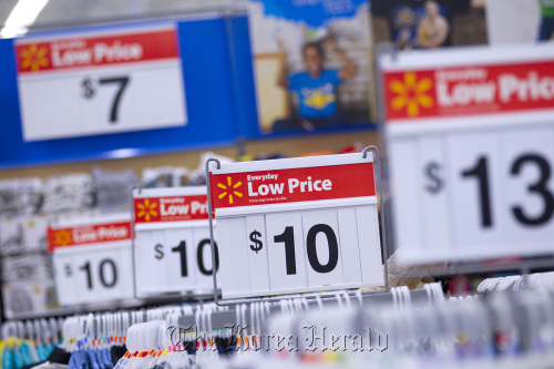 “Everyday Low Price” signs are displayed at a Wal- Mart store in Secaucus, New Jersey.   Bloomberg