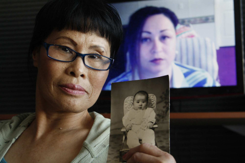 Diane Drinkwine (foreground) holds a baby picture of her biological daughter, Sally Blue (background)
who is on Skype, Jan. 26. (Los Angeles Times/MCT)