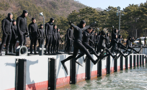 The Underwater Demolition Team (UDT) jumps into a cold water during a military training. (Yonhap News)
