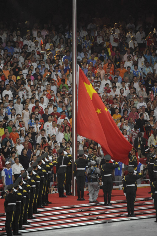 The Chinese flag is raised in the National Stadium during the opening ceremony on Friday, August 8, 2008, to kick off the Games of the XXIX Olympiad in Beijing, China.(MCT)