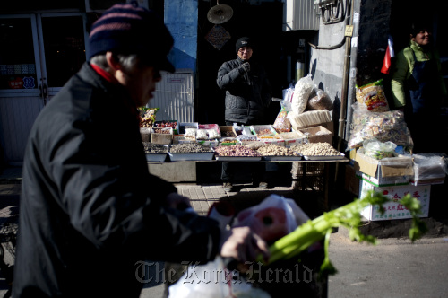 Vendors sell vegetables at a produce market in Beijing. Bloomberg