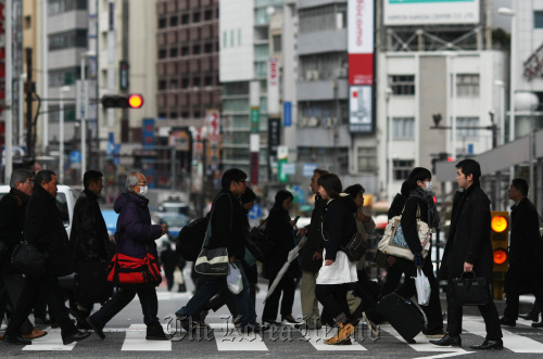 Morning commuters make their way to work at a station in Tokyo.  Bloomberg
