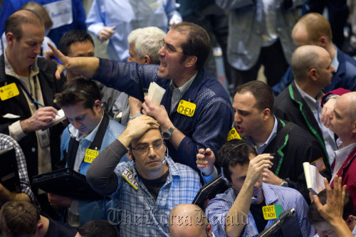 Traders work in the crude oil options pit at the New York Mercantile Exchange in New York.  Bloomberg