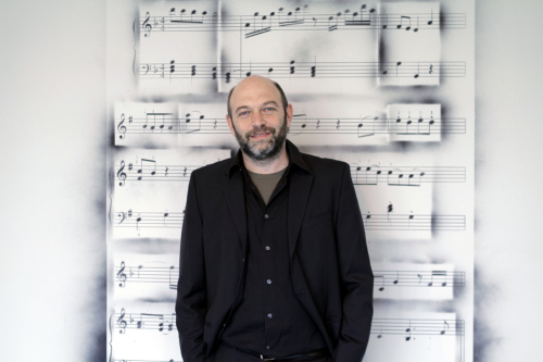Carlos Amorales poses in front of one of his “Graffiti Songs” series (SongEun ArtSpace)