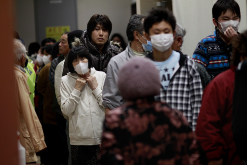 Evacuees line for meals in a shelter in Soma city, Fukushima prefecture, Japan, Monday, March 14, 2011, three days after a massive earthquake and tsunami struck the country's north east coast. On top of the losses of family and friends along with property, evacuees in the area are now faced with the fears of radiation contamination from damaged nuclear facilities near by.(AP)