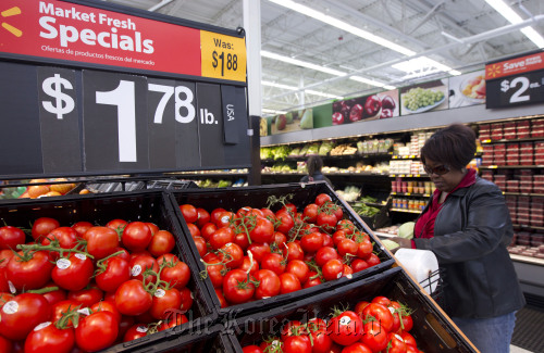 A customer shops for produce at a Wal-Mart store in Secaucus, New Jersey.  Bloomberg