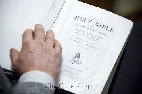 Pastor Chris Huff, of Bible Baptist Church, in Mount Prospect, Illinois, holds his copy of the King James translation of the Bible.  Chicago Tribune/MCT