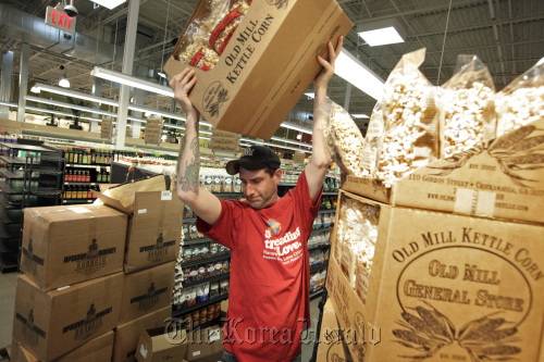 Craig Bernier sets up a display of organic popcorn at a Whole Foods store in Raleigh, North Carolina, March 10.  Raleigh News & Observer/MCT