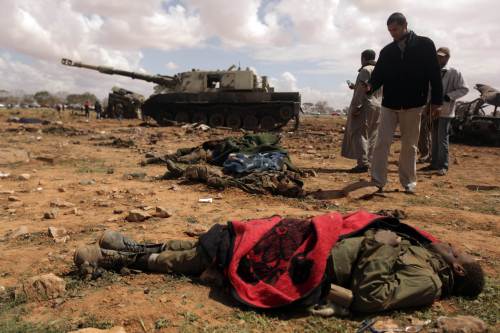 <YONHAP PHOTO-1115> TOPSHOTS Curious Libyan onlookers take pictures of dead African teenagers, members of Moamer Kadhafi forces on March 20, 2011 in al-Wayfiyah, 35 km West of Benghazi hit by French warplanes. TOPSHOTS / AFP PHOTO / PATRICK BAZ /2011-03-21 07:02:21/ <저작권자 ⓒ 1980-2011 ㈜연합뉴스. 무단 전재 재배포 금지.>
Libyan onlookers take pictures of dead teenagers, members of Moammar Gadhafi’s forces, on Sunday in al-Wayfiyah, 35 km West of Benghazi, after it was hit by French warplanes.  AFP-Yonhap News