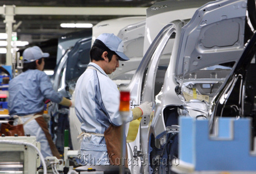 Workers assemble a Toyota Motor Corp. vehicle on the production line of Central Motor Co.’s Miyagi plant in Ohira Village, Miyagi Prefecture, Japan. Bloomberg