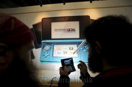 Attendees play the Nintendo 3DS at a game developers conference in San Francisco, California, U.S.
Bloomberg
Attendees play the Nintendo 3DS at a game developers conference in San Francisco, California, U.S.
Bloomberg