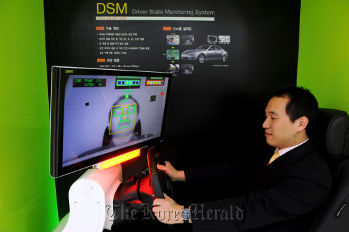 A visitor tries the driven-state monitoring system simulator.
