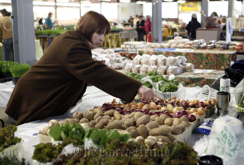 Ann Malzberg shops at the Cinzori Family Farms stand at the Royal Oak Farmers Market on March 26 in Royal Oak, Michigan.
Detroit Free Press/MCT