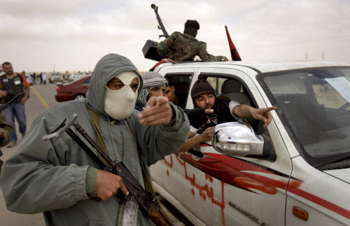 <YONHAP PHOTO-0515> Libyan rebel fighters point to the distance as black smoke rises on the skyline, unseen, near Brega, Libya, Wednesday, April 6, 2011. NATO rejected criticism from Libyan rebels over the pace of its military campaign in Libya, saying Wednesday that its airstrikes against Moammar Gadhafi's forces are increasing every day. (AP Photo/Ben Curtis)/2011-04-07 07:27:08/ <저작권자 ⓒ 1980-2011 ㈜연합뉴스. 무단 전재 재배포 금지.>
Libyan rebel fighters point to the distance as black smoke rises on the skyline (unseen), near Brega, Libya, Wednesday.  AP-Yonhap News