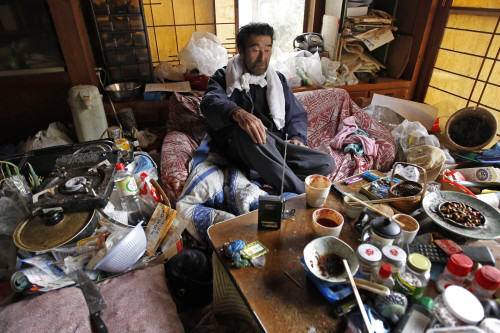 Kunio Shiga listens to a battery-powered radio in the living room of his home in Minami Soma, Fukushima Prefecture, inside the deserted evacuation zone established for the 20 kilometer radius around the Fukushima Dai-ichi nuclear complex in northeastern Japan Friday, April 8, 2011. The 75-year-old man was stranded alone in his farmhouse ever since Japan's monstrous tsunami struck nearly a month ago. (AP-Yonhap News)