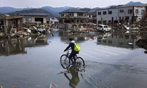 A man rides a bicycle in the tsunami-hit prefecture of Miyagi in Japan on Monday. (Yonhap-AP)
