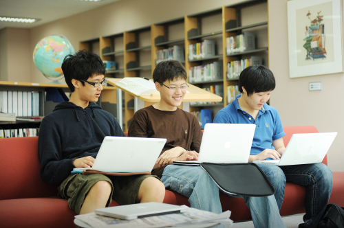 Students at the Korea International School study on their laptops as part of the school’s one-to-one education program. Korea International School