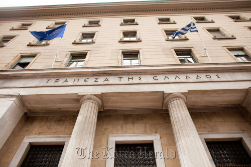 Greek and European Union flags fly outside the Bank of Greece headquarters in Athens.  Bloomberg