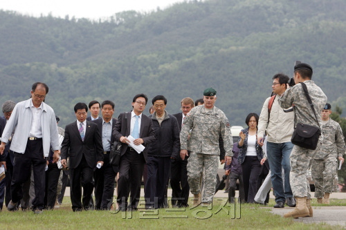 23일 경북 칠곡군 왜관읍 캠프 캐럴 기지에서 민관합동조사단 관계자들이 고엽제가 매립지로 추정되는 헬기장 인근을 둘러보고 있다. <사진공동취재단>
David Fox (right), brigadier general of Installation Management Command Korea, and Grand National Party lawmaker Lee In-ki (second from right) visit the site as part of a Korea-U.S. joint investigation into the alleged burial of Agent Orange at Camp Caroll in Waegwan, North Gyeongsang Province, Monday. Joint Press Corps