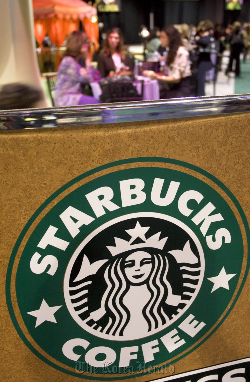 Women sit at a Starbucks Coffee lounge in Long Beach, California.  Bloomberg