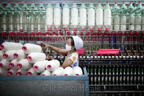 A worker manufactures cotton yarn at a factory in Dali county, Shaanxi province, China.
Bloomberg