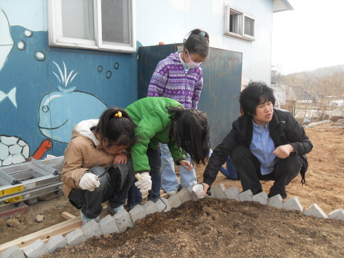 Heemangteo toilet before
Children and Heemangteo president Jun Jin-kyoung tend the center’s garden.  Heemangteo
Children and Heemangteo president Jun Jin-kyoung tend the center’s garden.  Heemangteo
