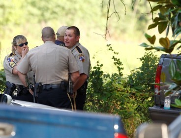 Law enforcement officials are on the scene of a home in Hardin, Texas Tuesday, June 7, 2011, after receiving an anonymous tip that multiple dismembered bodies were buried there. A sheriff's spokesman said officials were seeking a search warrant for the property. (AP)