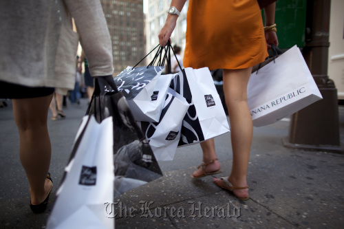 Pedestrians carry shopping bags in New York.  Bloomberg