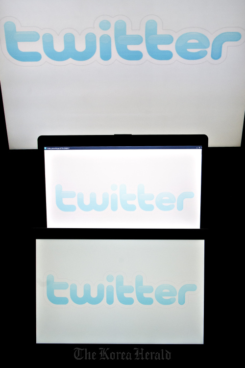 Twitter Inc. logos are displayed on computer screens. Bloomberg