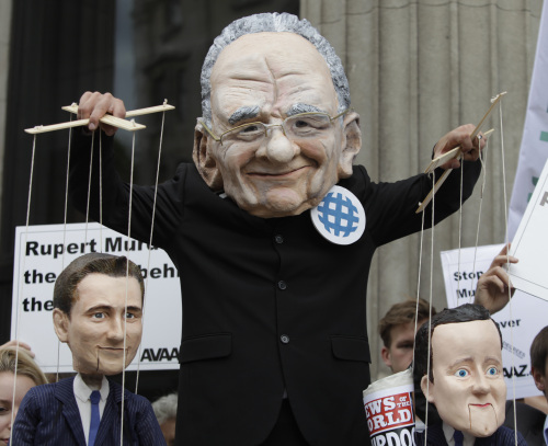 <YONHAP PHOTO-0039> A demonstrator, wearing a mask depicting Rupert Murdoch,holding puppets depicting British Prime Minister David Cameron, right, and British Culture minister Jeremy Hunt, left, protests with others outside the Department of Culture Media and Sport in central London to show their opposition to the proposed sale of BSkyB to Murdoch's News International, Thursday, June 30, 2011. The British government has given Thursday, qualified approval to Rupert Murdoch's News Corp. to take full control of satellite broadcaster British Sky Broadcasting, but set further conditions. To allay concerns about media dominance, News Corp. had offered to spin off Sky News as a separate company. News Corp. already owns The Sun, Britain's largest-circulation newspaper, The Times, The Sunday Times and the Sunday tabloid News of the World. (AP Photo/Lefteris Pitarakis)/2011-07-01 00:09:39/ <저작권자 ⓒ 1980-2011 ㈜연합뉴스. 무단 전재 재배포 금지.>
Rupert Murdoch depicted by a demonstrator (left) and Rebekah Brooks, chief executive of News International, which publishes the News of the World tabloid.  AP-Yonhap News
Rupert Murdoch depicted by a demonstrator (left) and Rebekah Brooks, chief executive of News International, which publishes the News of the World tabloid.  AP-Yonhap News
Rupert Murdoch depicted by a demonstrator (left) and Rebekah Brooks, chief executive of News International, which publishes the News of the World tabloid.  AP-Yonhap News
Rupert Murdoch depicted by a demonstrator (left) and Rebekah Brooks, chief executive of News International, which publishes the News of the World tabloid.  AP-Yonhap News