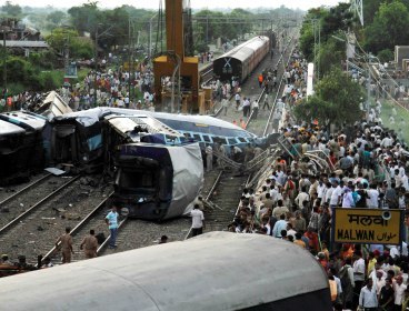 Officials and residents gather around the wreckage of the Kalka Mail passenger train which derailed near the town of Fatehpur in Uttar Pradesh state, India, Sunday, July 10, 2011. (AP)