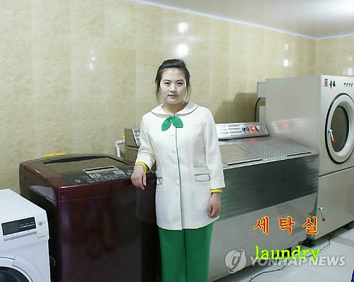 A North Korean worker poses at a laundry room of a luxury restaurant-leisure resort opened in Pyongyang in a joint venture with a European company.(Yonhap)