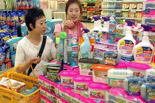 Customers pick out dehumidifying agents and deodorants at a supermarket in Seoul.   Yonhap News