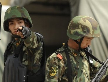 Armed Chinese paramilitary police officers are seen on guard in Urumqi.(AFP)