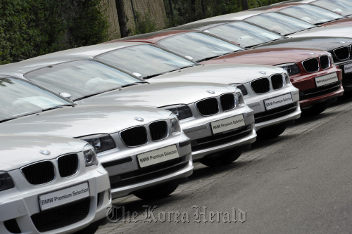 BMW 1-Series automobiles sit on display at a BMW dealership in Ingolstadt, Germany.  Bloomberg