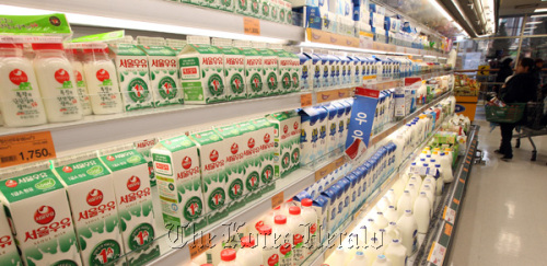 Consumers pass by a milk products grocery shelf in Seoul on Friday.  Yonhap News