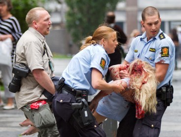 A young victim is helped in the center of Oslo, Norway on Friday, July 22, 2011, after a bomb ripped open buildings in the heart of Norway's government. (AP)
