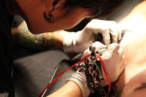 “Khan” inking the skin of a foreigner at his tattoo shop.
Yonhap News