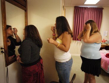This file photo shows fat women checking their looks in front of mirror. (MCT)